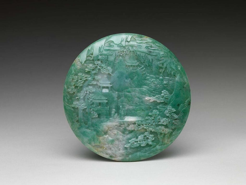 A green jadeite table scene, carved during the Qing Dynasty era in China.